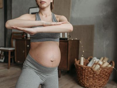 Soft hands resting on a yoga mat during practice.
